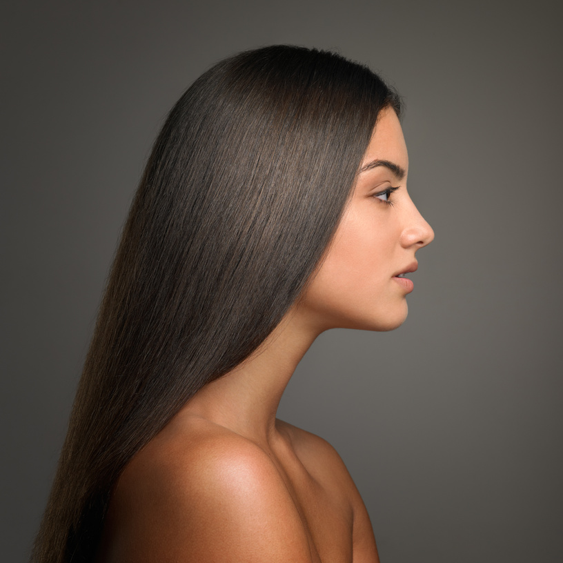 profile of young attractive brunette with straight hair